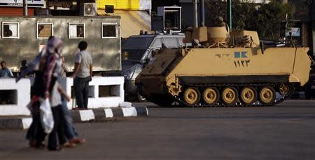 Egyptian army soldiers on an armoured personnel carrier (APC) and riot police take their position around Tahrir Square in Cairo, October 2, 2013, as members of the Muslim Brotherhood and supporters of ousted Egyptian president Mohamed Mursi planned another protest at the square. REUTERS/Amr Abdallah Dalsh