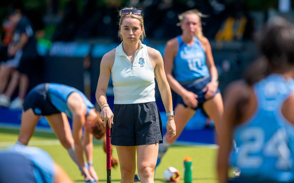 North Carolina field hockey coach Erin Matson walks amongst her players as they stretch prior to their overtime period against Iowa on Sunday, August 27, 2023 at Karen Shelton Stadium in Chapel Hill, N.C.