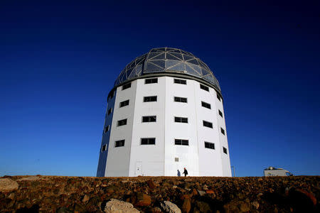 A man walks past the dome housing the Southern African Large Telescope (SALT), located near Sutherland in South Africa's Karoo region, November 9, 2005. REUTERS/Mike Hutchings