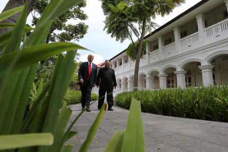 FILE PHOTO: U.S. President Donald Trump and North Korea's leader Kim Jong Un walk together before their working lunch during their summit at the Capella Hotel on the resort island of Sentosa, Singapore June 12, 2018. REUTERS/Jonathan Ernst/File Photo