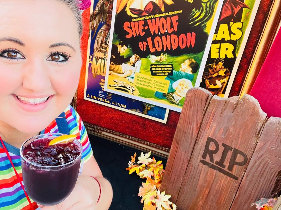 carly holding specialty drink at halloween horror nights in hollywood