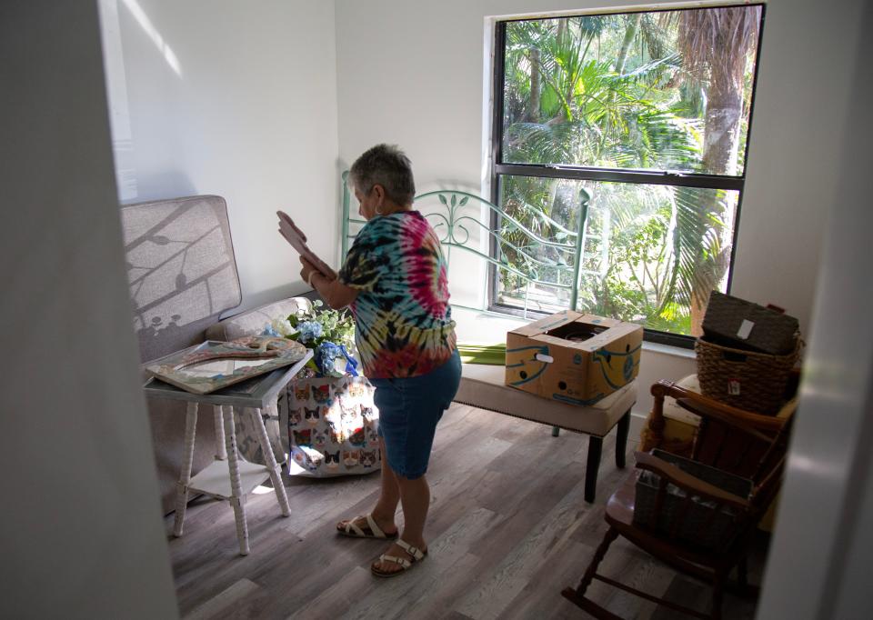 Linda Norton unpacks some of her decorations for her condo on Friday, Oct. 27, 2023, in Fort Myers. Her Island Park Village condo was flooded in Hurricane Ian.