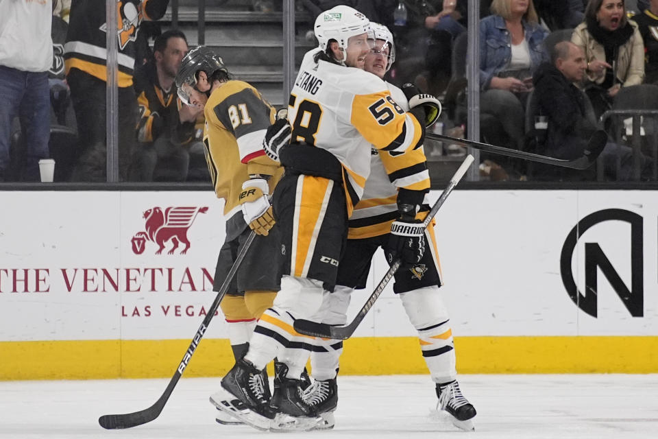 Pittsburgh Penguins defenseman Kris Letang (58) embraces left wing Jake Guentzel (59) after Guentzel scored against the Vegas Golden Knights during the second period of an NHL hockey game Saturday, Jan. 20, 2024, in Las Vegas. (AP Photo/John Locher)