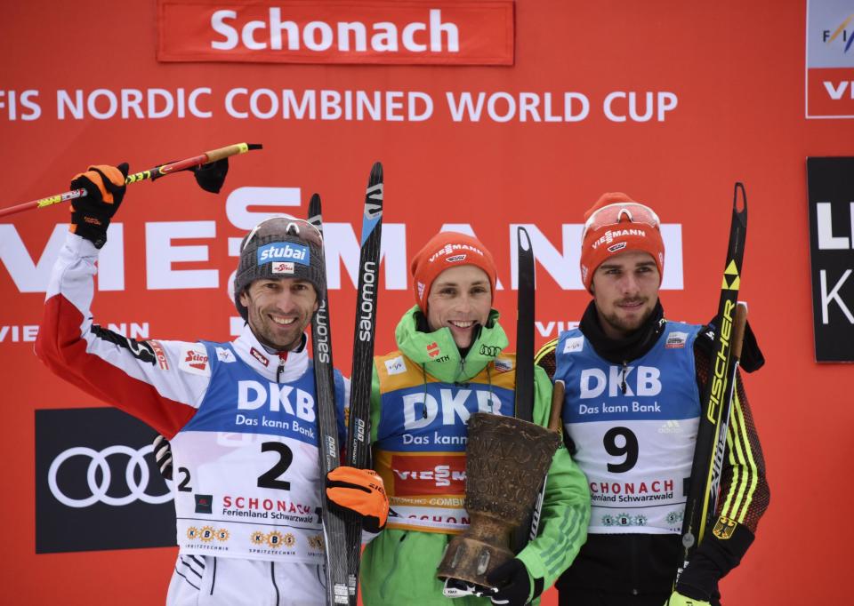 Second placed Austrian Wilhelm Denifl, Germany's winner Eric Frenzel and third placed German Johannes Rydzek, from left, celebrate on the podium after the Nordic Combined World Cup in Schonach, Germany, Saturday, March 18, 2017. (Patrick Seeger/dpa via AP)