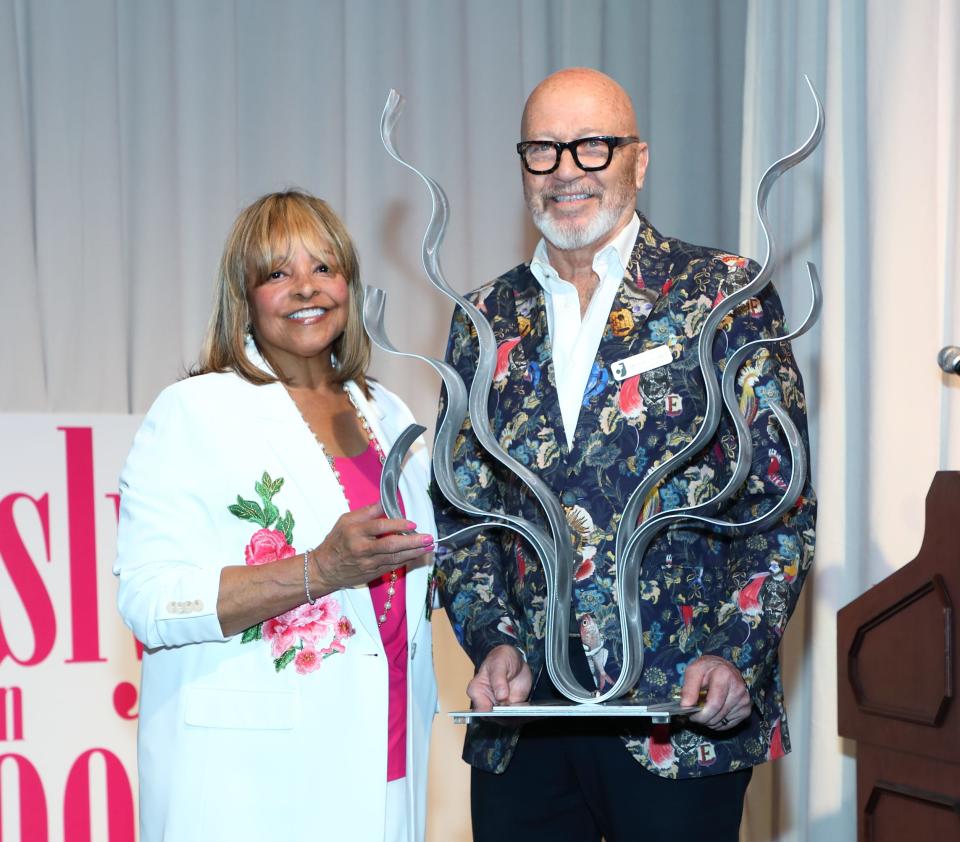 Beverly Fitzgerald accepts her award from Michael Plante at The Joslyn Center's "Joslyn in Bloom" fashion show luncheon, held April 12, 2024.