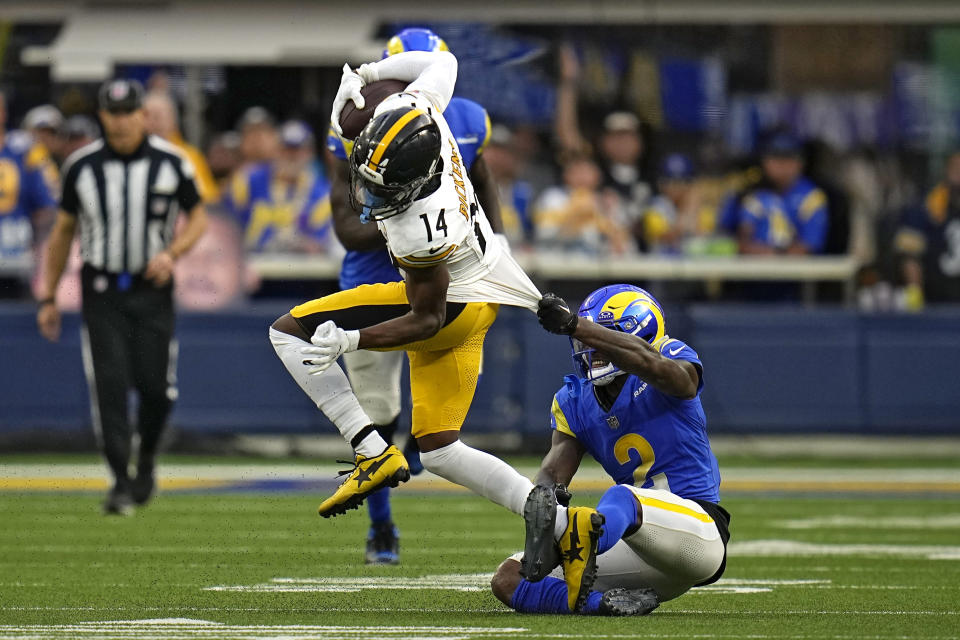 Pittsburgh Steelers wide receiver George Pickens, left, runs a pass as Los Angeles Rams safety Russ Yeast defends during the second half of an NFL football game Sunday, Oct. 22, 2023, in Inglewood, Calif. (AP Photo/Gregory Bull)