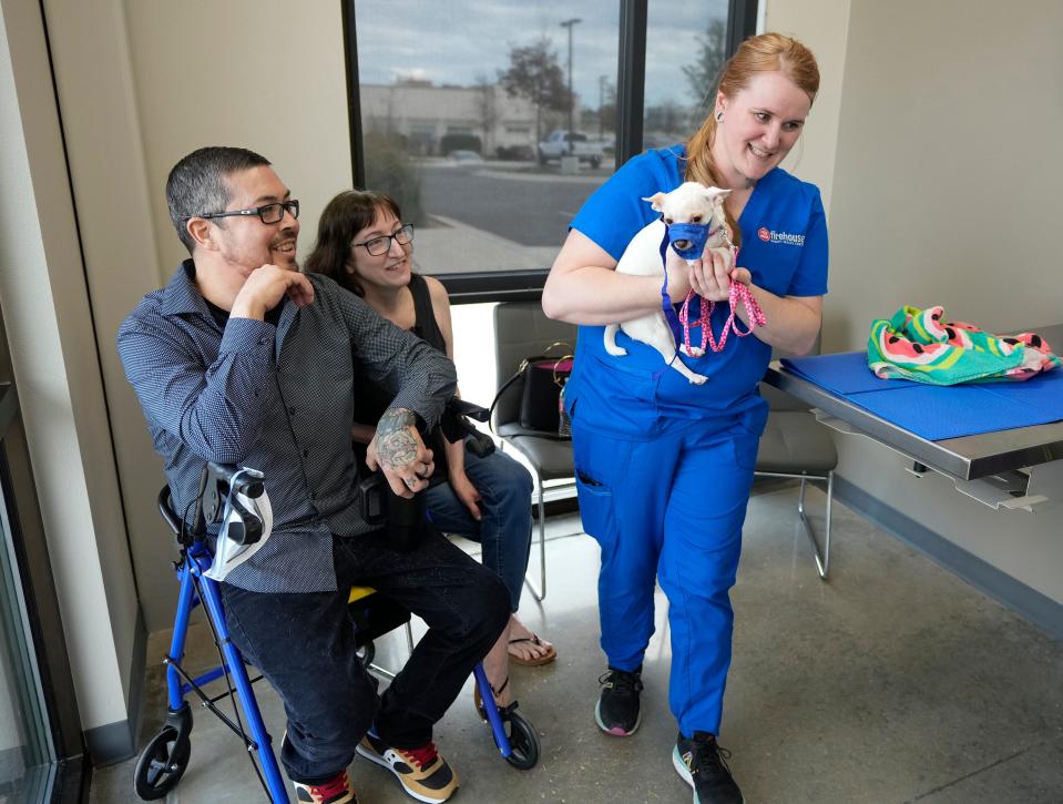 Charles and Nicole Richard watch veterinary technician Morgan Shannon take Chulita, one of their Chihuahuas, for an examination at Firehouse Animal Health Center in Kyle last month. Firehouse is donating $10,000 worth of veterinary care to the Statesman’s Season For Caring campaign, including for the Richards’ two Chihuahuas.