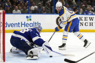 Tampa Bay Lightning goaltender Andrei Vasilevskiy (88) stops a shot by Buffalo Sabres left wing Zach Benson (9) during the first period of an NHL hockey game Monday, April 15, 2024, in Tampa, Fla. (AP Photo/Chris O'Meara)