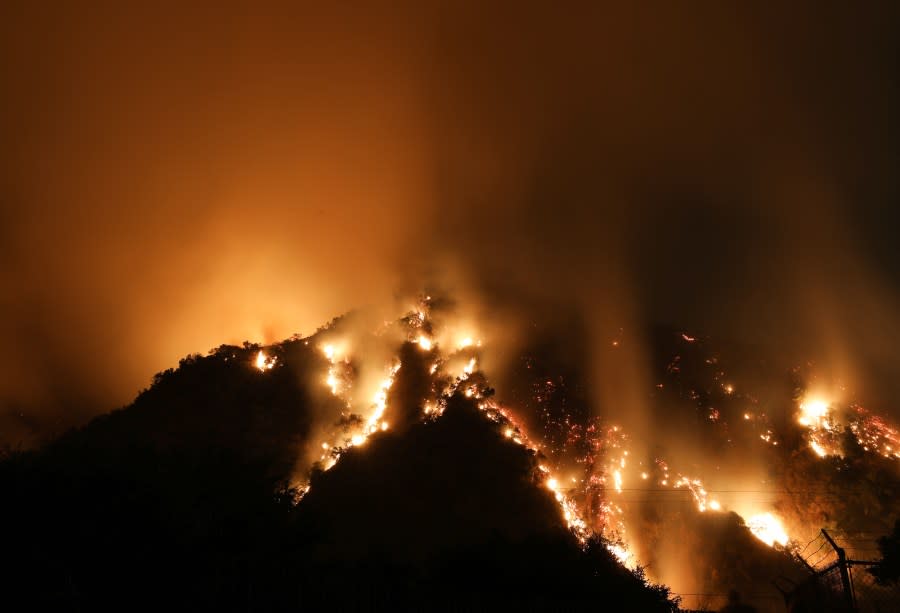 MONROVIA, CALIFORNIA – SEPTEMBER 15: Smoke and flames are blurred in a long exposure as the Bobcat Fire burns down a hillside near homes on September 15, 2020 in Monrovia, California. California’s national forests remain closed due to wildfires which have already incinerated a record 2.5 million acres this year. The Bobcat Fire, burning in the San Gabriel Mountains, has grown to over 40,000 acres. (Photo by Mario Tama/Getty Images)