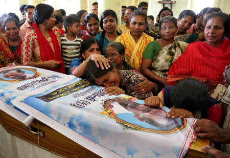 Relatives of a man who died during the floods mourn during his funeral at a church in Paravur, in the southern state of Kerala, India August 21, 2018. REUTERS/Sivaram V