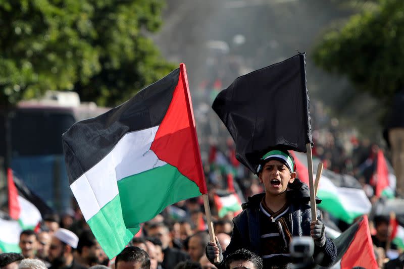 Palestinians take part in a protest ahead of the announcement by U.S. President Donald Trump of his long-delayed Mideast peace plan, in Gaza City