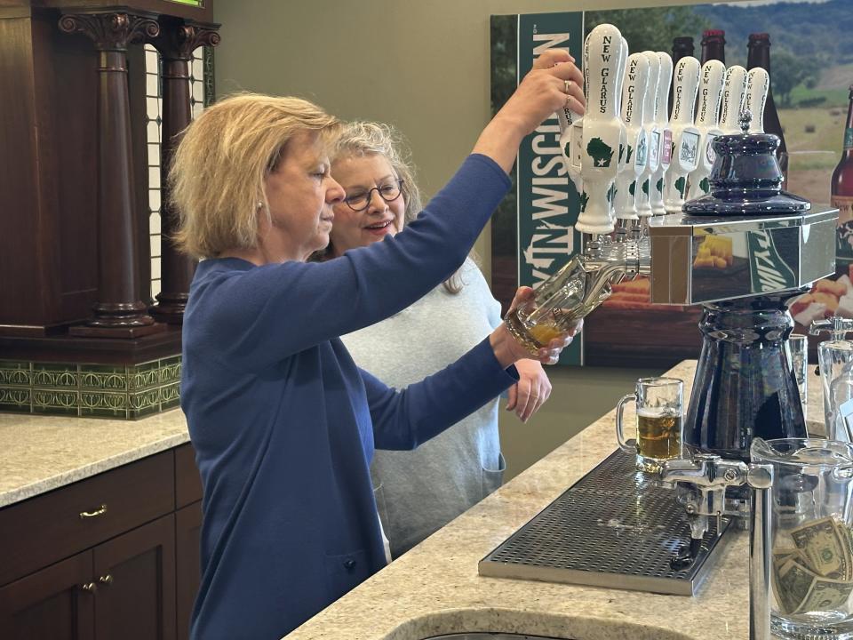 Wisconsin Democratic U.S. Sen. Tammy Baldwin talks to New Glarus Brewing Company co-owner Deb Carey during a campaign stop, Thursday, March 28, 2024, in New Glarus, Wis. The stop was part of her campaign launch tour in a race against Republican Eric Hovde the could determine who has majority control of the Senate. The Wisconsin Senate race between Democratic Sen. Tammy Baldwin and Republican Eric Hovde is setting up as one of the most competitive and expensive Senate races in the country. (AP Photo/Scott Bauer)