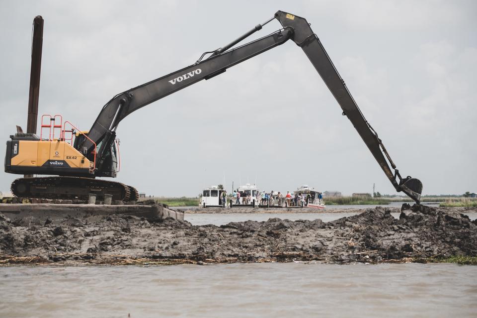 A crane builds terraces, similar to a small levee, Tuesday near Raccourci Bay in southwestern Terrebonne Parish, about seven miles from the Gulf of Mexico. The project is one of two that aims to blunt wave action that is eroding wetlands in the area.