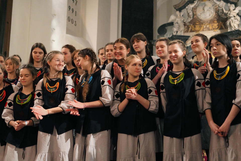 Shchedryk youth choir members listen to chief conductor Marianna Sablina following a Christmas concert at Copenhagen’s Church of the Holy Spirit, in Copenhagen, Denmark, Thursday, Dec. 8 2022. The Shchedryk ensemble, described as Kyiv’s oldest professional children’s choir, were in the Danish capital this week for a performance as part of an international tour that also took them to New York’s famed Carnegie Hall. (AP Photo/James Brooks)