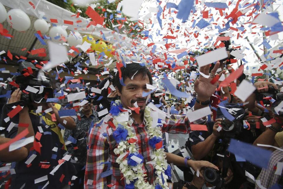 It would be cause for celebration among many boxing fans if Manny Pacquiao (center) and Floyd Mayweather finally meet in the ring. (AP Photo/Aaron Favila)