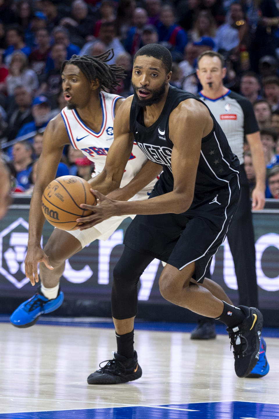 Brooklyn Nets' Mikal Bridges, right, drives to the basket after getting past Philadelphia 76ers' Tyrese Maxey, left, during the first half of an NBA basketball game, Sunday, April 14, 2024, in Philadelphia. (AP Photo/Chris Szagola)