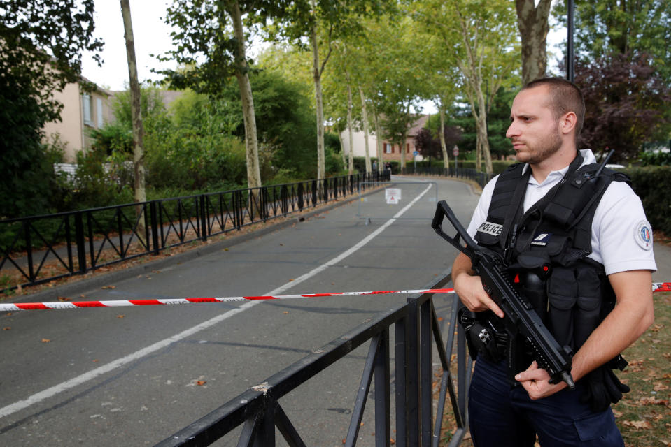 <em>French police guard the scene of the knife in the town of Trappes (Reuters)</em>