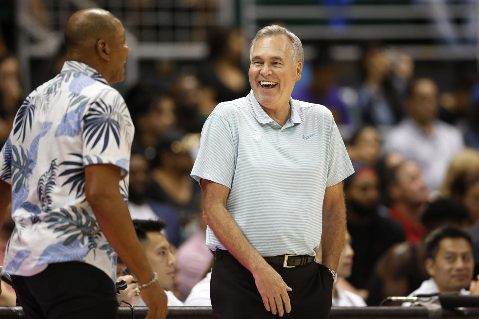 Los Angeles Clippers' head coach Doc Rivers, left, and Houston Rockets' head coach Mike D'Antoni talk on the sidelines during the second quarter of an NBA preseason basketball game, Thursday, Oct 3, 2019, in Honolulu. (AP Photo/Marco Garcia)