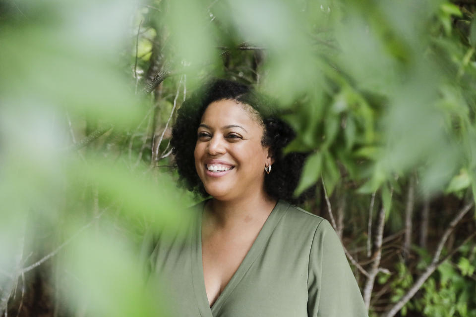 FILE - In this Friday, July 24, 2020 file photo, Charisse Davis, who serves on the Cobb County School Board, poses for a portrait in Marietta, Ga. On the Saturday that news organizations called the presidential race for Joe Biden, Davis popped a bottle of champagne, despite a nagging sense of sadness, then packed the family into the car to head into downtown Atlanta and join thousands dancing in the street. She decided to just enjoy victory. “We’ll go back to worrying about humanity tomorrow,” she said to her family as they climbed in the car. And then tomorrow arrived, and the worry roared back. (AP Photo/Brynn Anderson)