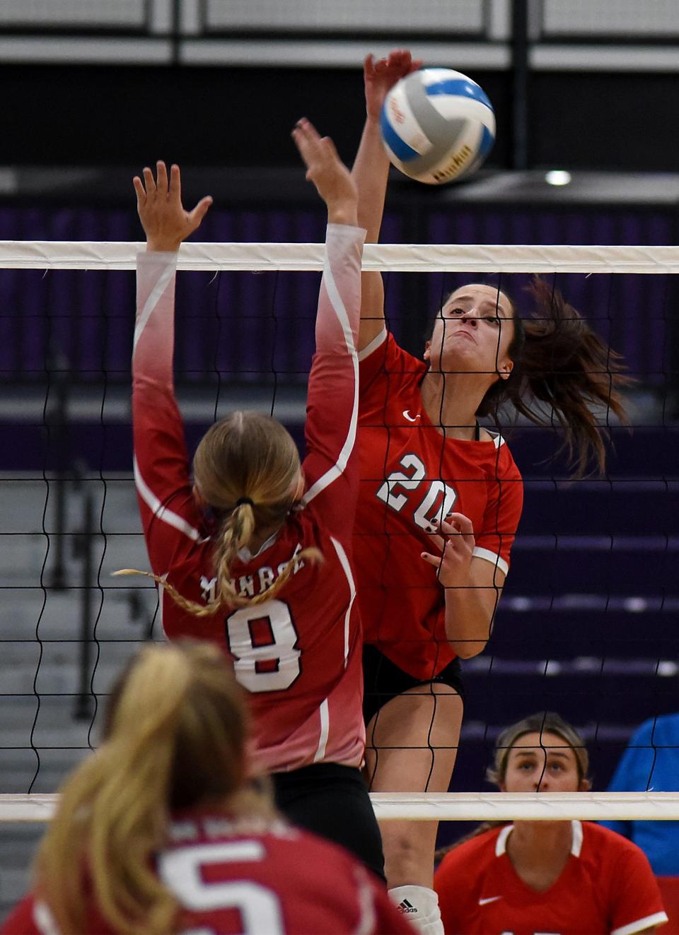 Alivia Brown of Bedford hammers a spike past Monroe's Addy Simmons of Monroe in the opening match of the Division 1 District at Woodhaven on Monday, October 30, 2123.