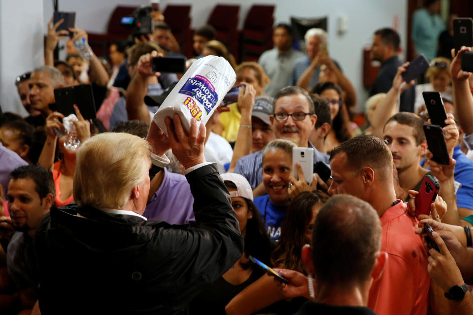 President Donald Trump tosses rolls of paper towels to people at a hurricane relief distribution center at Calvary Chapel in San Juan, P.R., on Oct. 3. (Reuters/Jonathan Ernst)