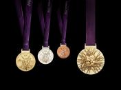 A handout image obtained from the London 2012 organising committee (LOCOG) on July 27, 2011 shows the London 2012 Olympic medals designed by British artist David Watkins. The Olympic medals’ circular form is a metaphor for the world. The front of the medal always depicts the same imagery at the summer Games, the Greek Goddess of Victory, Nike, stepping out of the depiction of the Parthenon to arrive in the host city. The design for the reverse of the London 2012 Olympic medals contains five main symbolic elements: the dished background suggests a bowl similar to the design of an amphitheatre, the core emblem is an architectural expression, a metaphor for the modern City, the grid brings both a pulling together and sense of outreach on the design - an image of radiating energy that represents the athletes’ achievements and effort, the River Thames is a symbol for London and the square is the final balancing motif of the design, opposing the overall circularity of the design and emphasising its focus on the centre and reinforcing the sense of ‘place’ as in a map inset. AFP PHOTO / LOCOG/ HO ATTENTION - EMBARGO, RELEASABLE Wednesday July 27, 2011 at 1830 GMT - THIS RESTRICTION APPLIES TO ALL MEDIA INCLUDING WEBSITES ---- EDITORS NOTE ---- RESTRICTED TO EDITORIAL USE - MANDATORY CREDIT *AFP PHOTO / LOCOG/ HO* - NO MARKETING NO ADVERTISING CAMPAIGNS - DISTRIBUTED AS A SERVICE TO CLIENTS (Photo credit should read HO/AFP/Getty Images)