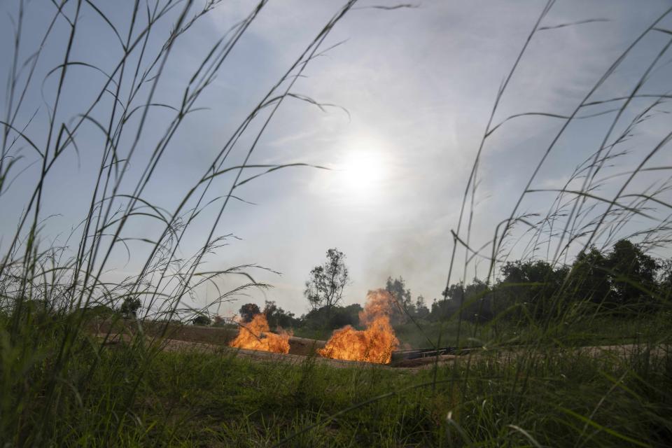 A burning flare is visible at an oil extraction area located in Moanda, Democratic Republic of the Congo, Saturday, Dec. 23, 2023. (AP Photo/Mosa'ab Elshamy)