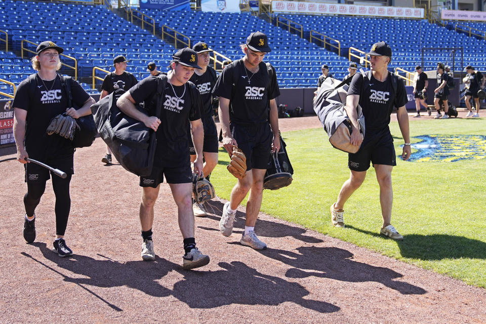 Birmingham-Southern players leave the field following practice Thursday, May 30, 2024, in Eastlake, Ohio. On Friday, the Panthers will continue an unexpected, uplifting season that has captured hearts across the country by playing in the Division III World Series on the same day the liberal arts college founded on the eve of the Civil War shuts its doors. (AP Photo/Sue Ogrocki)