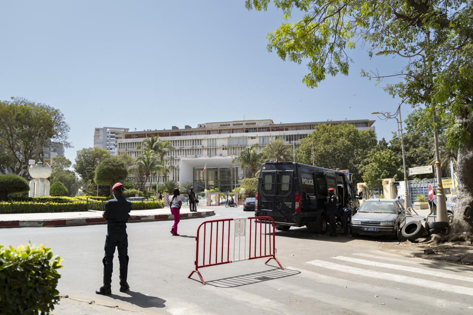 Senegalese police stand guard outside the National Assembly in Dakar, Senegal, Monday, Feb. 5, 2024. Senegal’s government restricted mobile internet access and impeded protesters Monday as federal lawmakers considered a bill to extend President Macky Sall’s tenure following his decision to postpone the country's Feb. 25 presidential election. (AP Photo/Sylvain Cherkaoui)