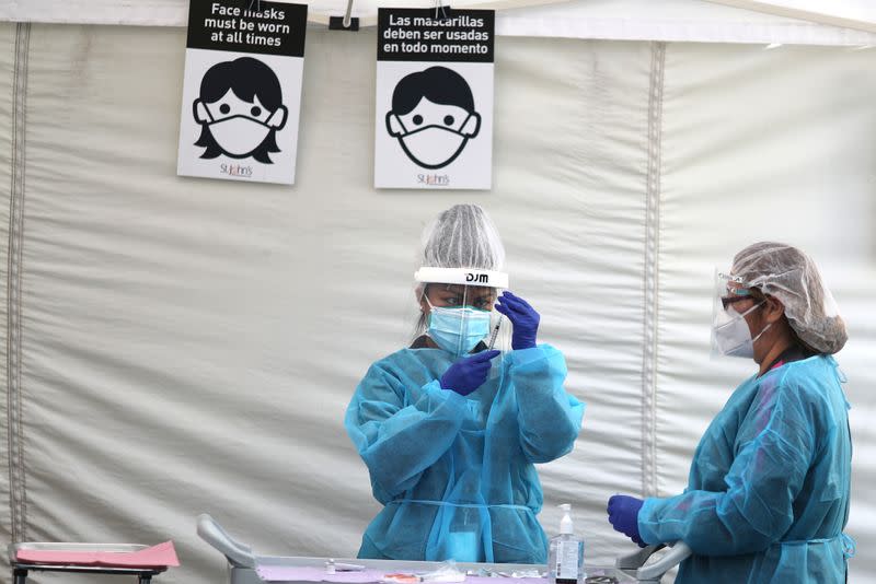 FILE PHOTO: Healthcare workers prepare Pfizer coronavirus disease (COVID-19) vaccinations in Los Angeles