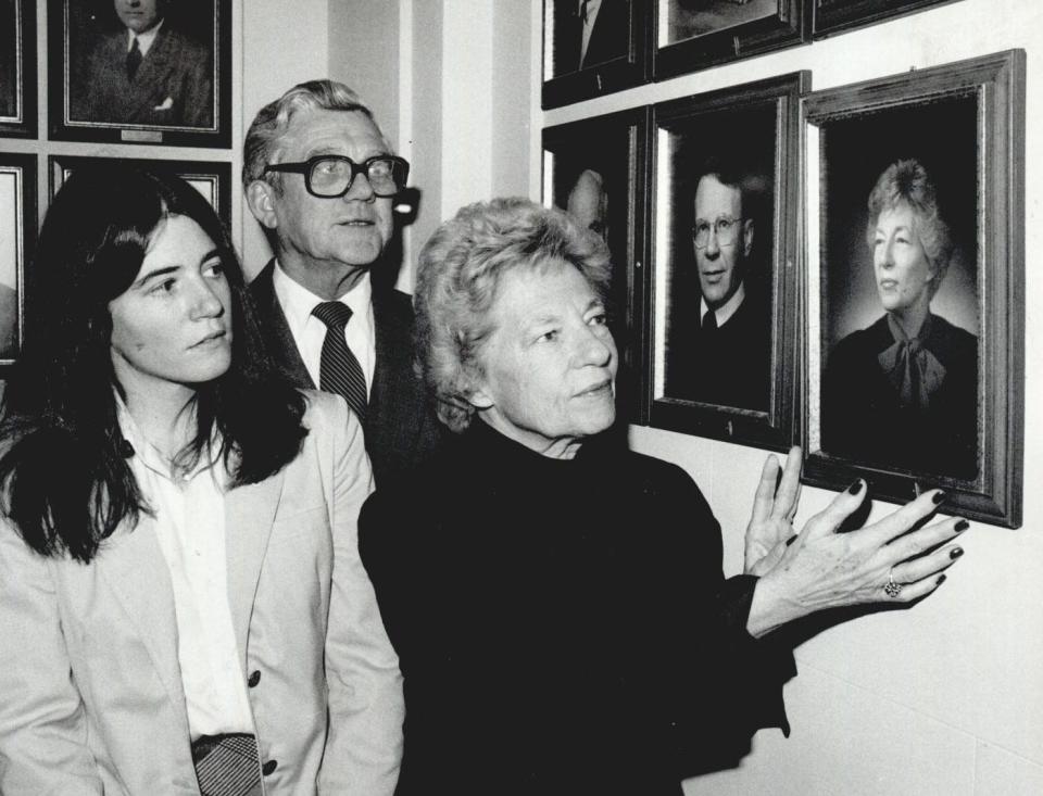 On Dec. 20, 1982, Oklahoma Supreme Court Justice Alma Wilson, the court's newest and first woman member, hangs a portrait of herself near her chambers at the state Capitol while her daughter, Lee Anne Zalko, and Chief Justice Pat Irwin watch.