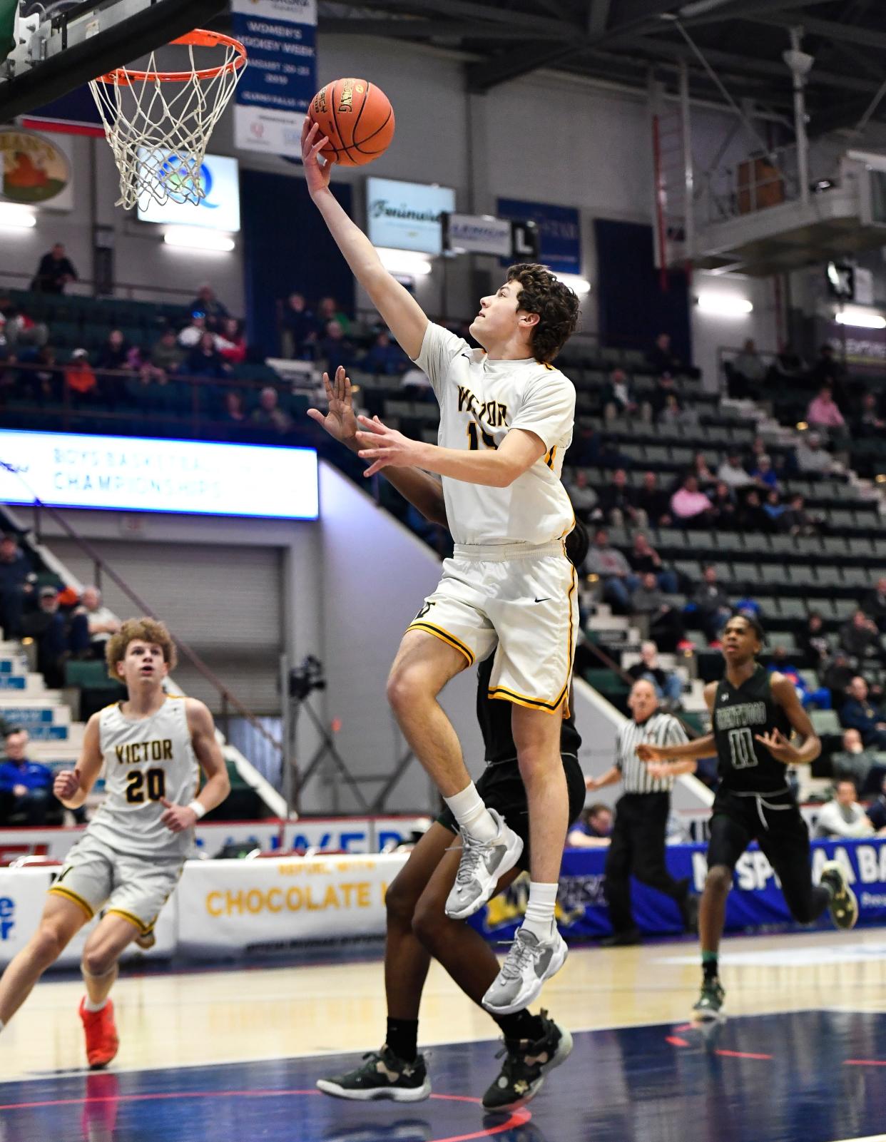 Victor's Garrett Clar drives for a layup during a NYSPHSAA Class AA Boys Basketball Championship semifinal in Glens Falls, N.Y., Friday, March 17, 2023. Victor advanced to the Class AA title game with a 56-41 win over Brentwood-XI.