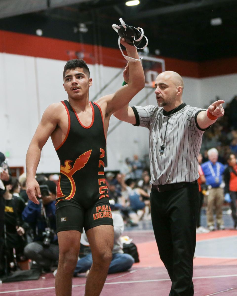A referee raises the hand of David Alonso of Palm Desert, the champion at 160 pounds at the CIF-SS Masters Meet on Friday at Palm Springs High School.