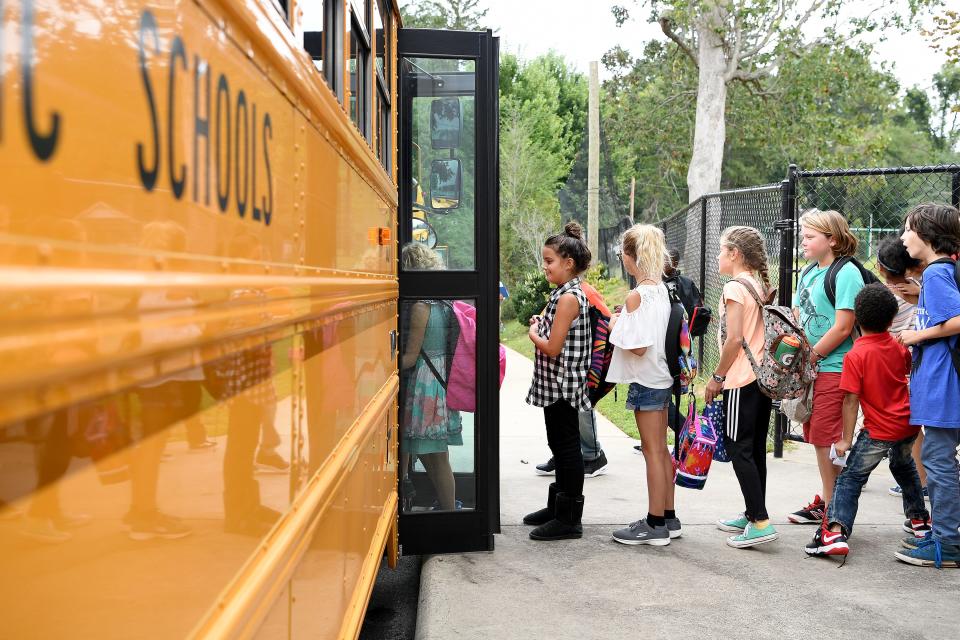 Students line up to get on their bus home at the end of the day at Claxton Elementary School on Monday, Aug. 28, 2017. 
