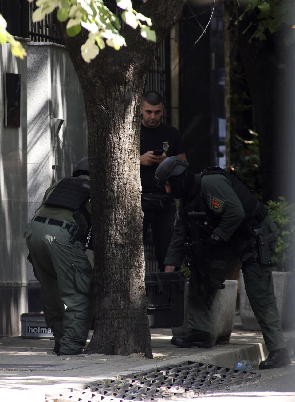 Albanian special police forces carry a box outside the Iranian Embassy in Tirana, Albania, Thursday, Sept. 8, 2022. The last staff of the Iranian Embassy in Tirana left the building Thursday after they were given 24 hours to leave Albania over a major cyberattack that the Albanian government blames on Iran. (AP Photo/Franc Zhurda)