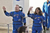 NASA astronauts Butch Wilmore, left, and Suni Williams wave as they leave the operations and checkout building for a trip to launch pad at Space Launch Complex 41 Wednesday, June 5, 2024, in Cape Canaveral, Fla. The two astronauts are scheduled to liftoff later today on the Boeing Starliner capsule for a trip to the international space station. . (AP Photo/Chris O'Meara)