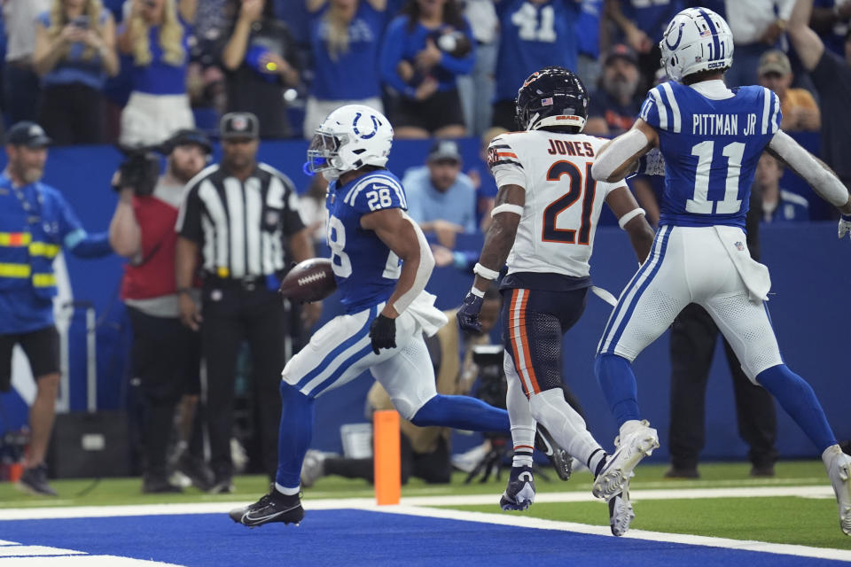 Indianapolis Colts running back Jonathan Taylor (28) scores a touchdown past Chicago Bears cornerback Jaylon Jones (21) during the first half of an NFL football game Sunday, Sept. 22, 2024, in Indianapolis. (AP Photo/Michael Conroy)