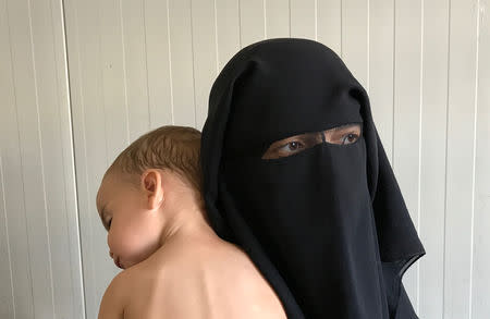 Chechen woman Laila Magomedovna Gazieva, the widow of an Islamic State militant, holds her son Obaida at Hammam Al-Alil camp south of Mosul, Iraq, September 13, 2017. REUTERS/Azad Lashkari.