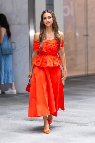 <p>Gotham/GC Images</p> Jessica Alba is seen in orange ensemble in Midtown on August 16, 2023 in New York City.