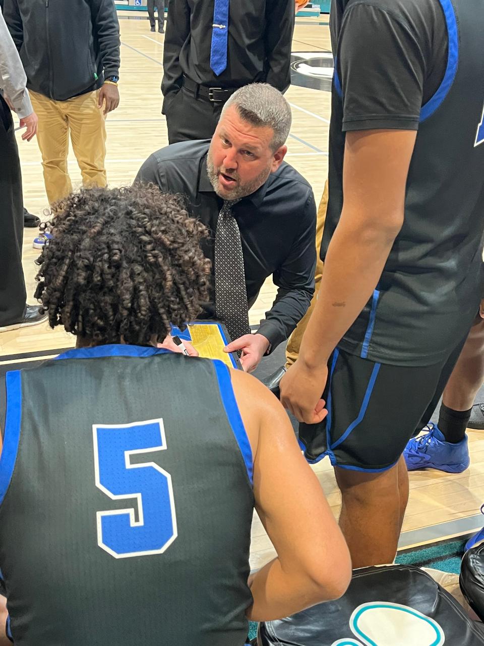 Wellington coach Matt Colin sets up a play during a timeout in Saturday's District 8-7A championship game against Lake Worth.