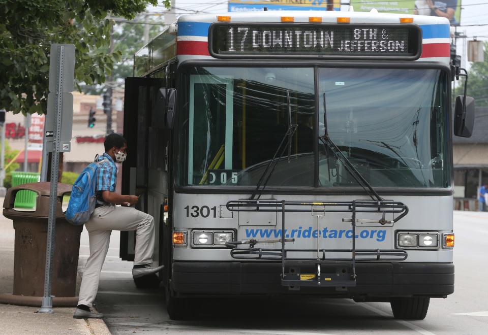 A passenger boards a TARC bus near Douglas Loop in the Highlands on Friday, July 17, 2020.