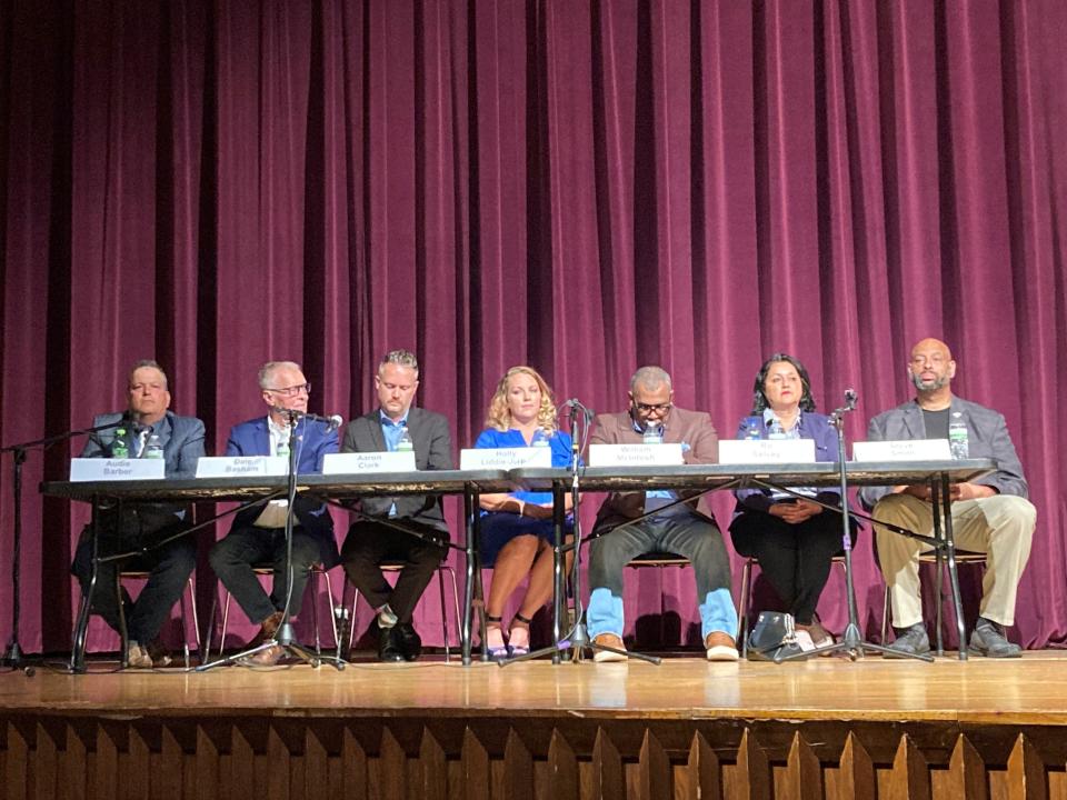candidates for Muncie's At-Large City Council seats awaits questions Wednesday n ight during a candidate forum at Muncie Central High School.