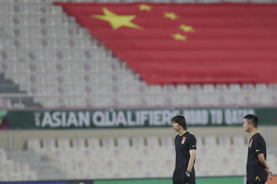 FILE - China's head coach Li Tie, left, attends the World Cup 2022 group B qualifying soccer match between China and Vietnam at Sharjah stadium in Sharjah, United Arab Emirates, Thursday, Oct. 7, 2021. China is missing out on the World Cup again despite spending millions — probably billions — to develop the game, a reported priority of Xi Jinping, the all-powerful general secretary of the Chinese Communist Party. (AP Photo/Kamran Jebreili, File)