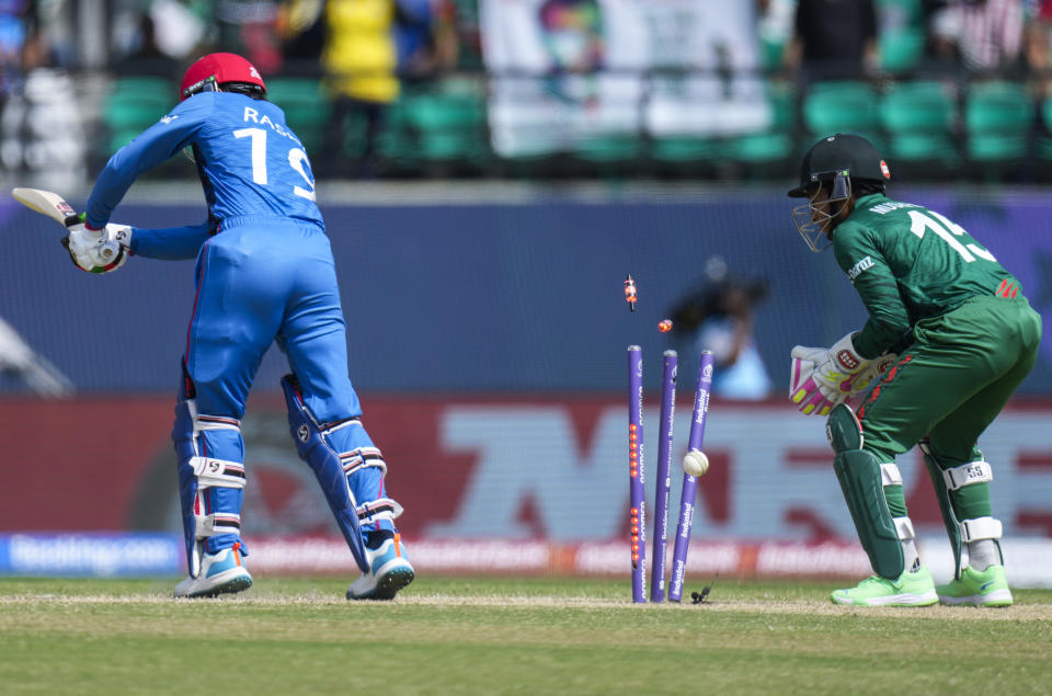 Afghanistan's Rashid Khan is bowled out by Bangladesh's Mehidy Hasan Miraz during the ICC Cricket World Cup match between Afghanistan and Bangladesh in Dharamsala, India, Saturday, Oct.7, 2023. (AP Photo/Ashwini Bhatia)