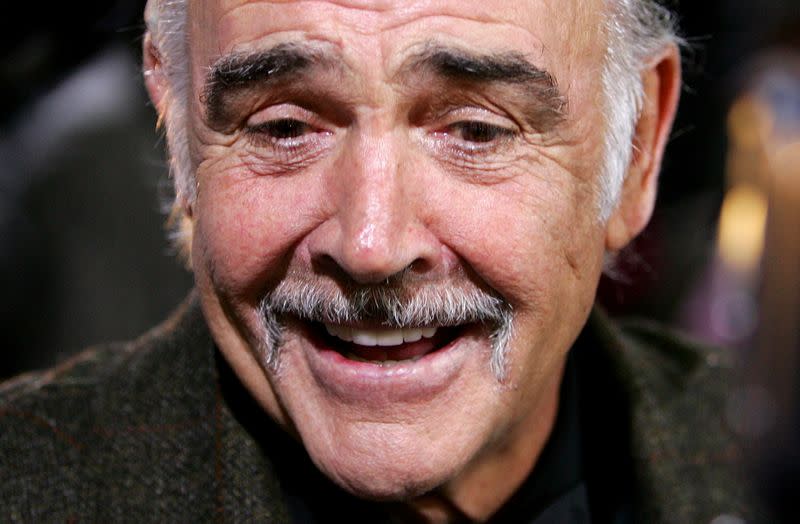 FILE PHOTO: British actor Connery smiles as he arrives on the red carpet for the European film award ceremony in Berlin
