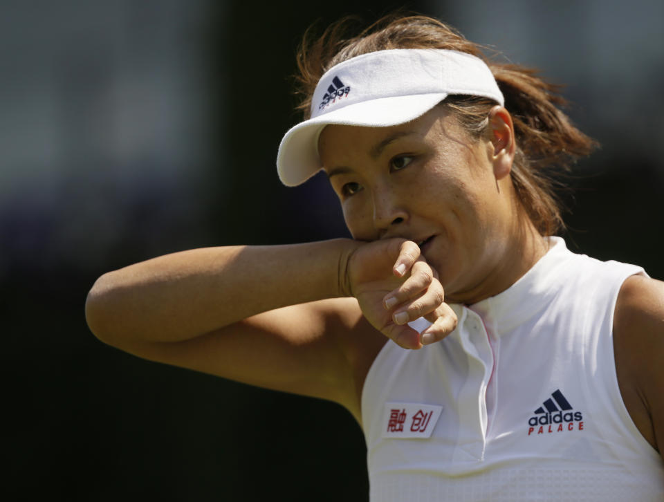 Peng Shuai of China wipes her face during the women's singles match against Samantha Stosur of Australia on the second day at the Wimbledon Tennis Championships in London, on July 3, 2018. China's Foreign Ministry is sticking to its line that it isn't aware of the controversy surrounding tennis professional Peng Shuai, who disappeared after accusing a former top official of sexually assaulting her. A ministry spokesperson said Friday that the matter was not a diplomatic question and that he was not aware of the situation. (AP Photo/Tim Ireland, File)