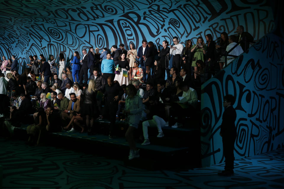 Attendees wait for the Christian Dior pre-fall 2020 men's fashion collection presentation to begin during Art Basel on Tuesday, Dec. 3, 2019, in Miami. (AP Photo/Brynn Anderson)