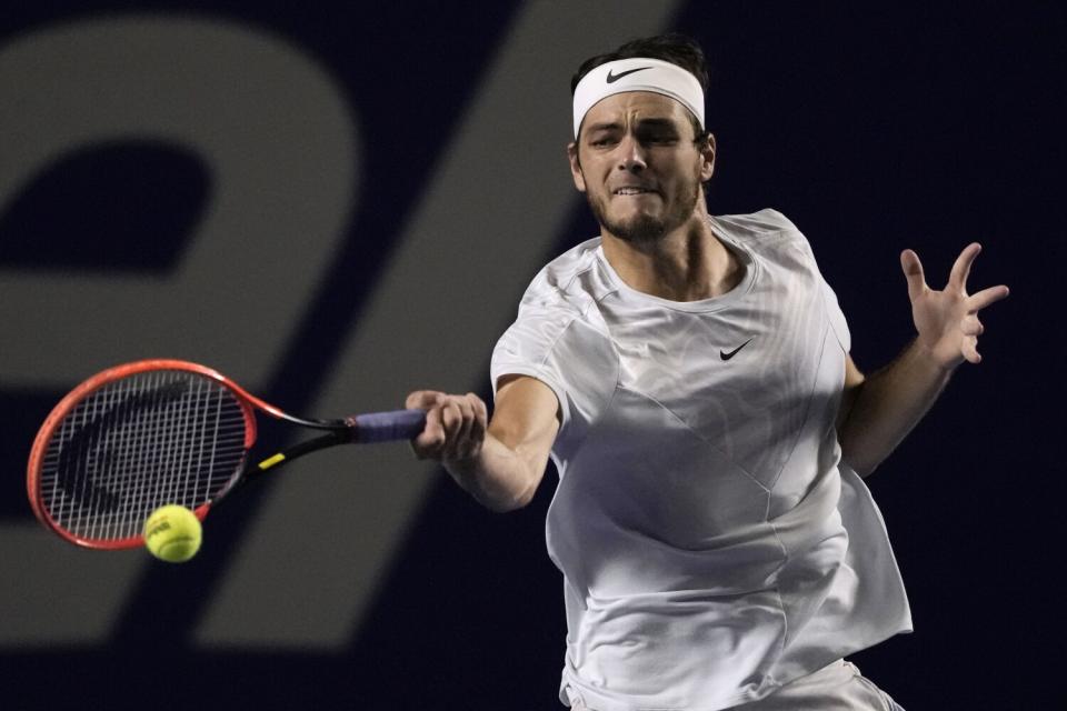 Taylor Fritz hits a forehand to Denis Shapovalov during a Mexican Open tennis tournament match in Acapulco, Mexico.