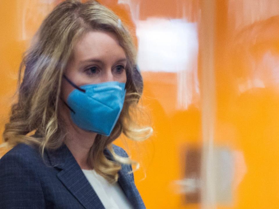 Theranos founder Elizabeth Holmes wears a blue mask in federal court
