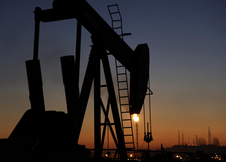 FILE - In this Jan. 18, 2016 file photo, an oil pump works at sunset, in the desert oil fields of Sakhir, Bahrain. The global energy transition is perhaps nowhere more perplexing than in the Arabian Peninsula. The political stability of the six Gulf states -- Saudi Arabia, the United Arab Emirates, Qatar, Kuwait, Bahrain and Oman -- is rooted in profits from fossil fuels. They are privately and publicly advocating for carbon capture technologies rather than a rapid phasing out of burning fossil fuels. (AP Photo/Hasan Jamali, File)